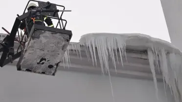 İtfaiye ekibi buz sarkıtlarını kırıyor