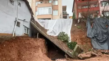 Çöken istinat duvarı ve hasar gören bina